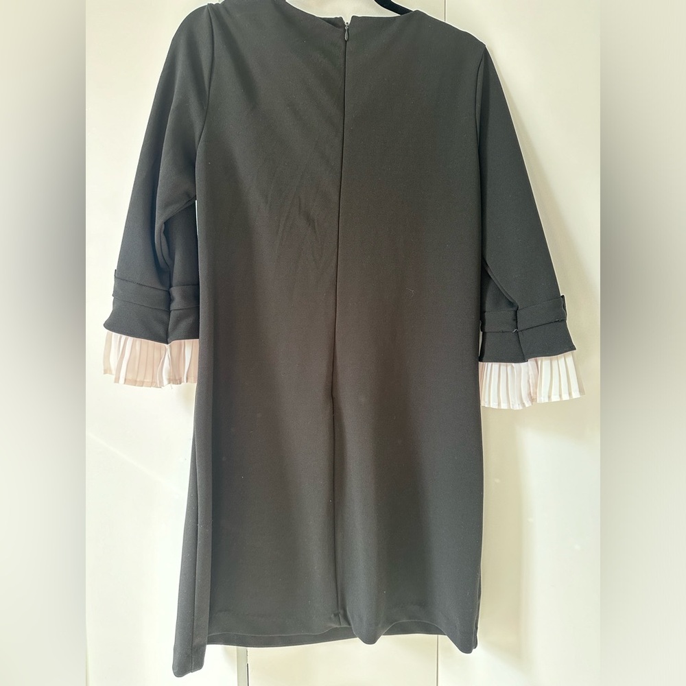 Neiman Marcus black dress with white ruffle and bow on sleeves